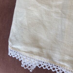 One fine linen embroidered tea towel. A muted butter yellow Vintage 1960s